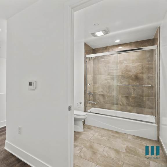 hall bathroom with shower bath with glass door