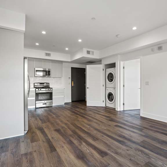 open-concept kitchen, dining, and living rooms with in-suite washer & dryer