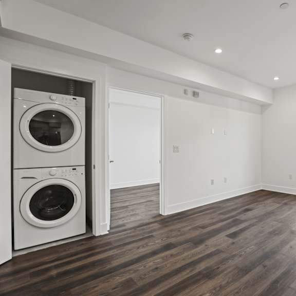in-suite washer& dryer, living zoom with large-windows, recessed lighting, and vinyl flooring