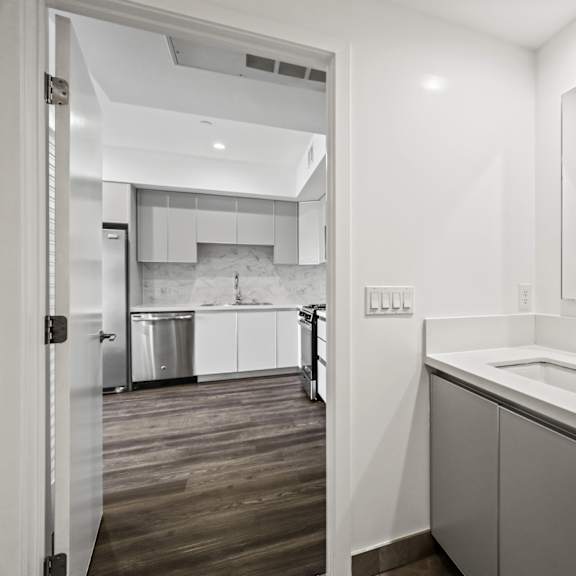 a white kitchen with a sink and a mirror