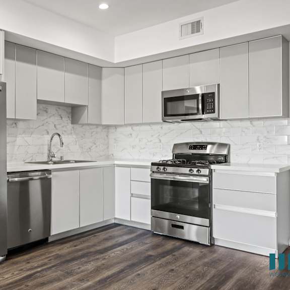 kitchen with energy-efficient refrigerator, dishwasher, stove, and microwave oven