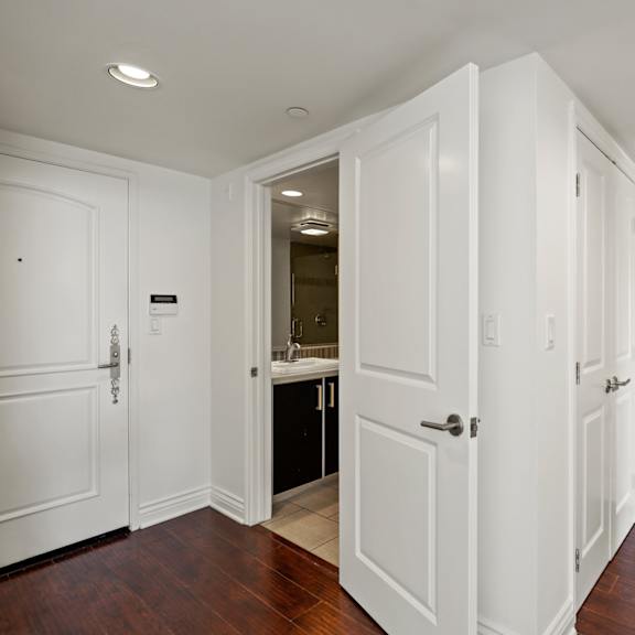 front entrance with hall bathroom and vinyl flooring