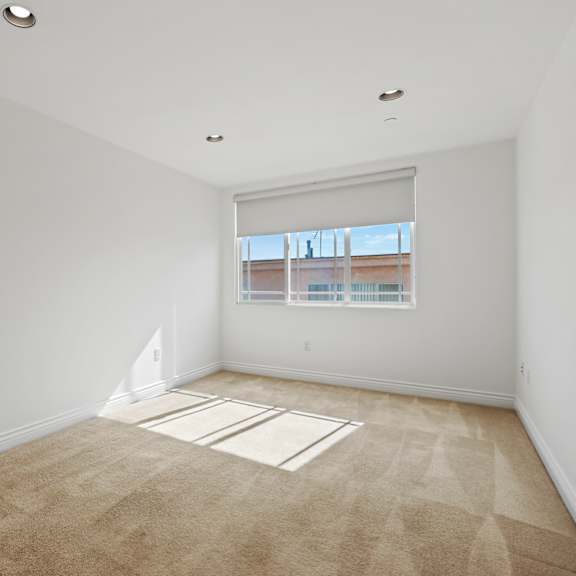 bedroom with recessed lighting and windows