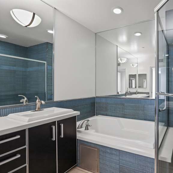 bathroom with bathtub and stand-up shower