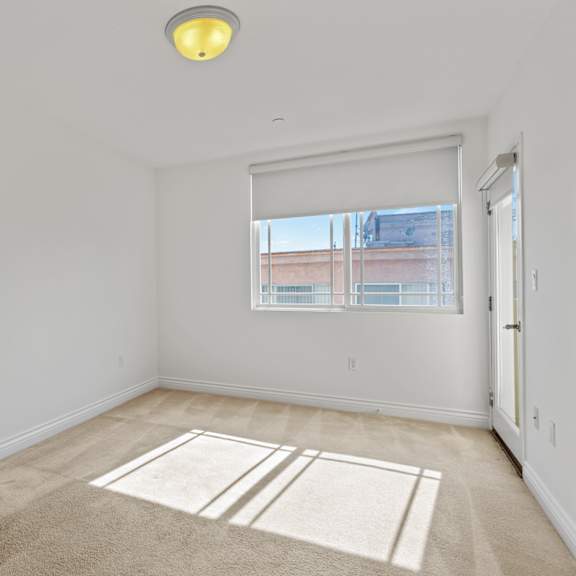 bedroom with patio and windows