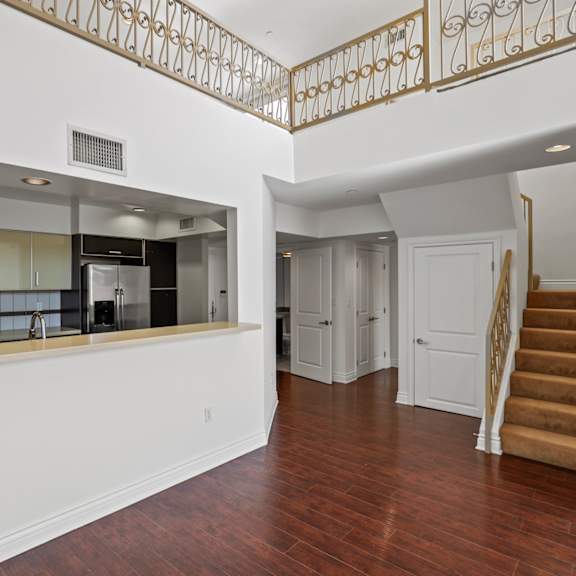 open-concept kitchen and staircase to loft space