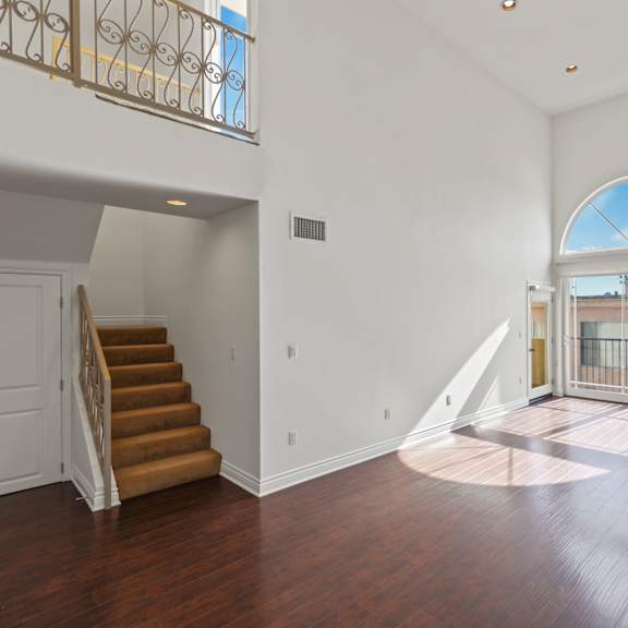 open-concept dining and living room with electric fireplace and patio