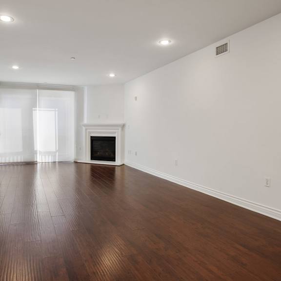 living room with electric fireplace, recessed lighting, vinyl flooring, and patio