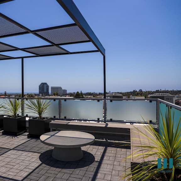 a roof terrace with a view of the city and a table and chairs