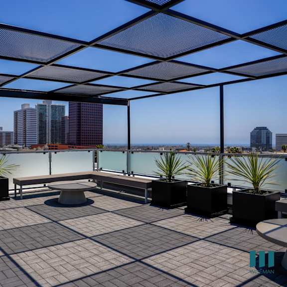 a roof terrace with a view of the city and a bench