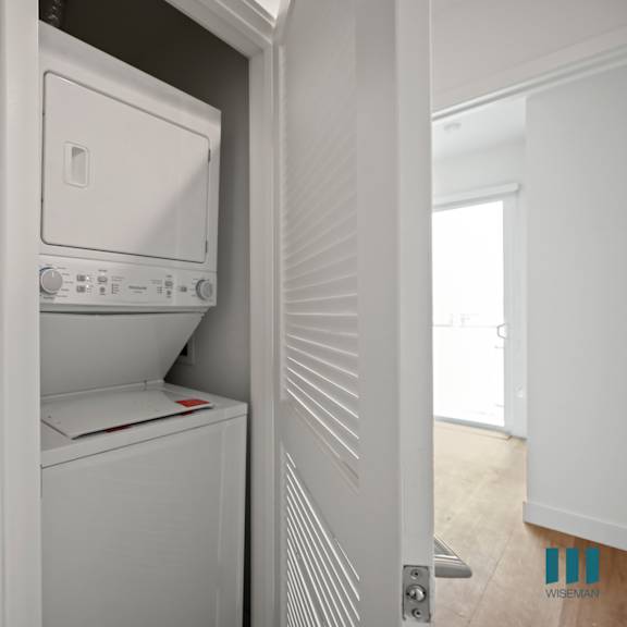 an empty laundry room with a washer and dryer