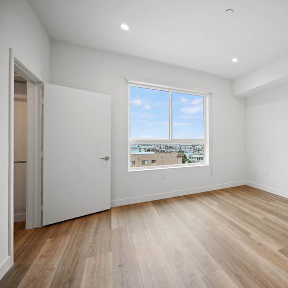 a view of a room with a window and a wooden floor