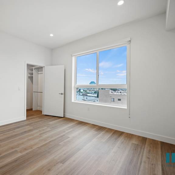 a living room with wood floors and a large window