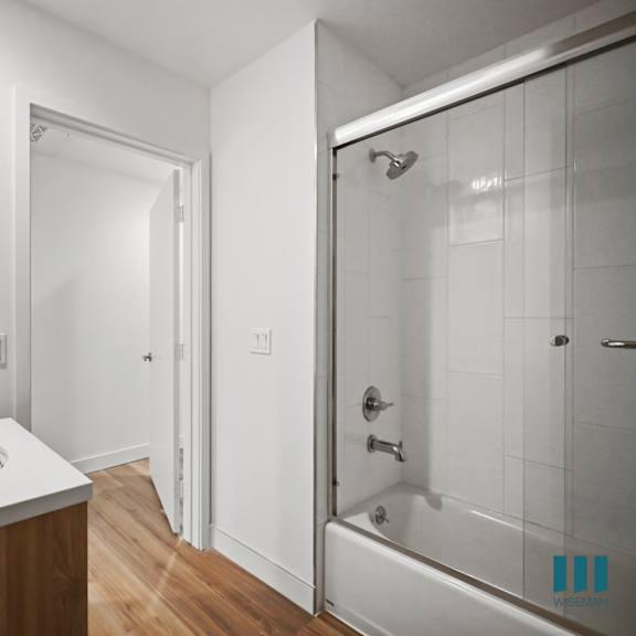 a bathroom with a sink and a shower and a mirror