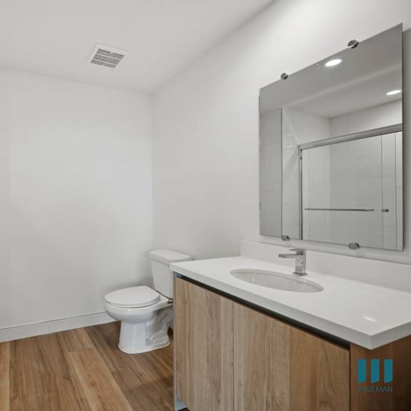 a bathroom with a toilet and a sink and a shower