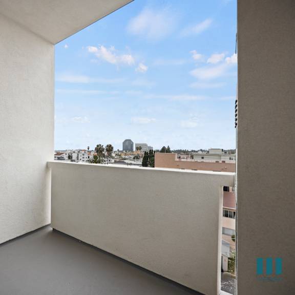 a balcony with a door and a view of the city
