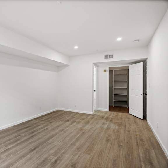 bedroom with walk-in closet with built-in organizers