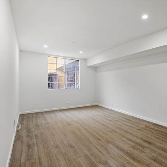 bedroom with vinyl flooring and windows