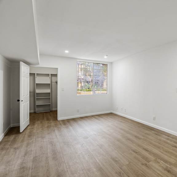 bedroom with large walk-in closet with built-in organizers
