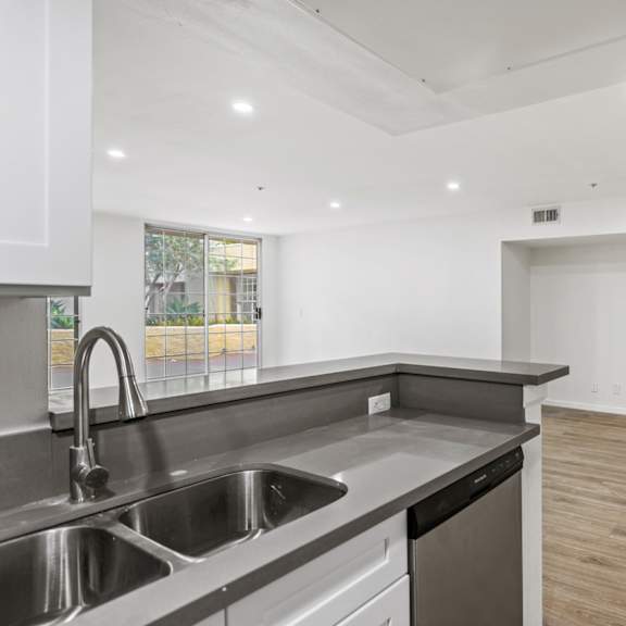 open-concept kitchen and dining area with recessed lighting and vinyl flooring