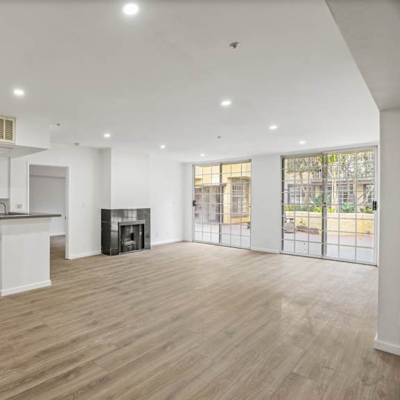 open-concept floor plan with electric fireplace, recessed lighting, vinyl flooring, and lots of windows with natural light
