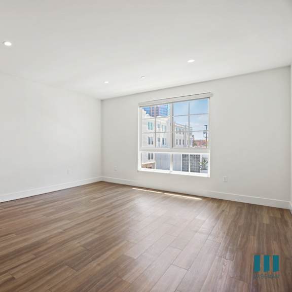 spacious bedroom wwith large-size window, vinyl flooring, and recessed lighting