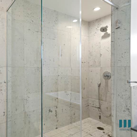 bathroom with large walk-in shower with glass door