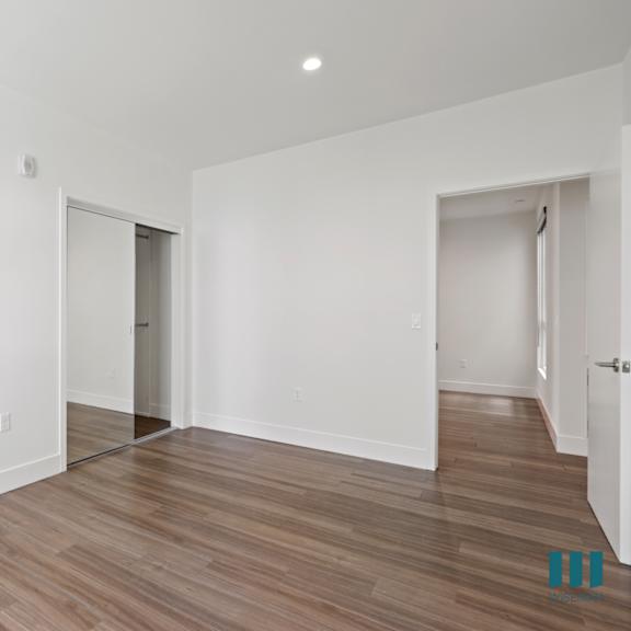 bedroom with mirrored closet, vinyl flooring, and recessed lighting