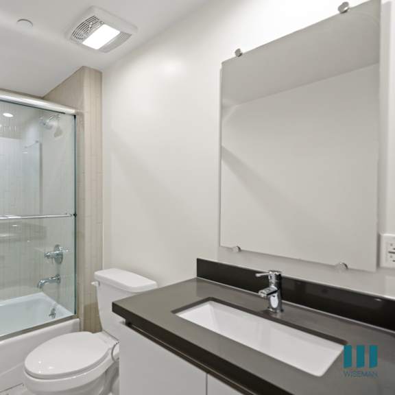 bathroom with full-size bathtub and glass door