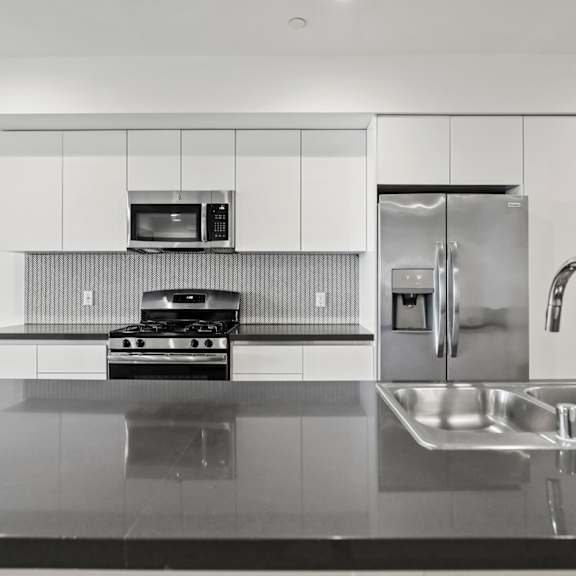 open-concept kitchen with energy-efficient appliances and countertop bar