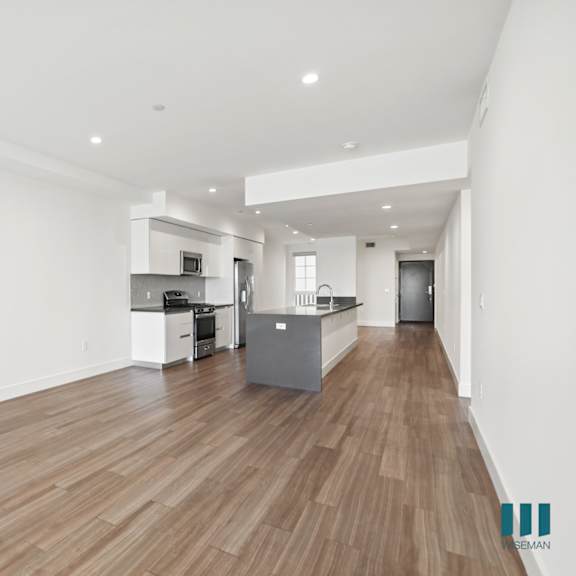 open-concept kitchen, dining, and living room areas