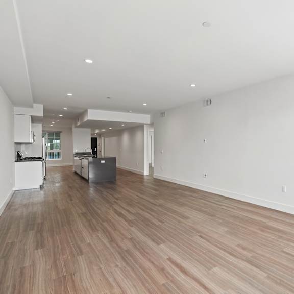 spacious living room with recessed lighting and vinyl flooring