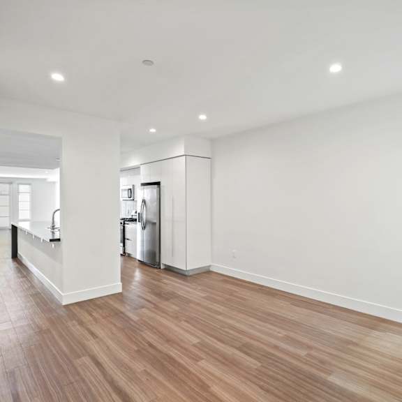 open-concept kitchen, dining, and living room areas