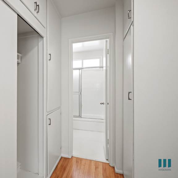 hallway with cabinet storage and bathroom