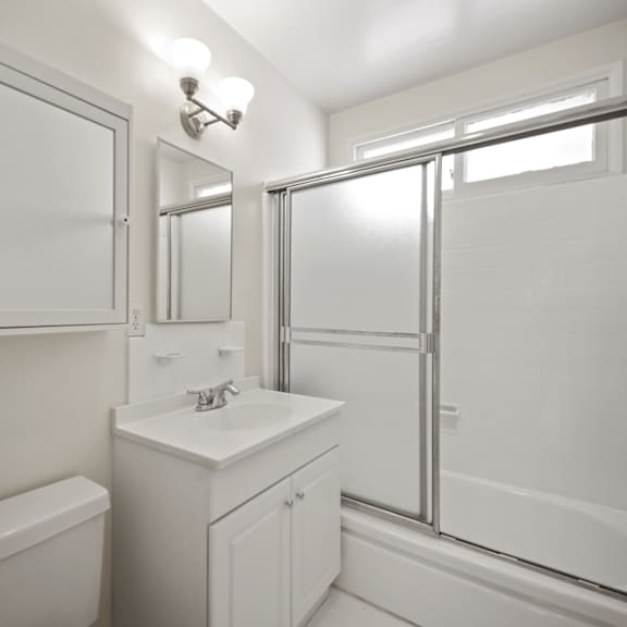 bathroom with shower bath and a glass door