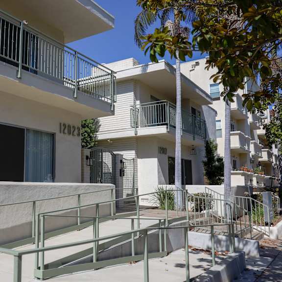 an apartment building with a staircase in front of it