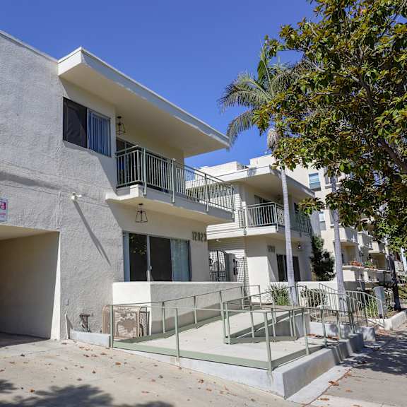 the exterior of a building with a staircase and a glass door