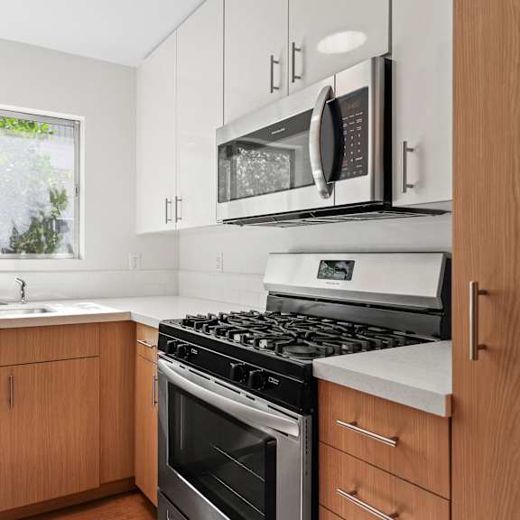 a kitchen with stainless steel appliances and wooden cabinets