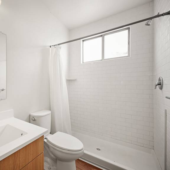 a bathroom with a sink toilet and a mirror