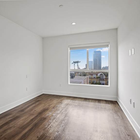 bedroom with large windows and vinyl flooring