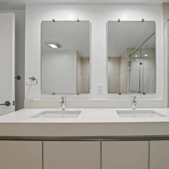 bathroom with double-sink vanity and cabinet storage