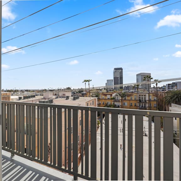 upper level unit with a patio with views of the city
