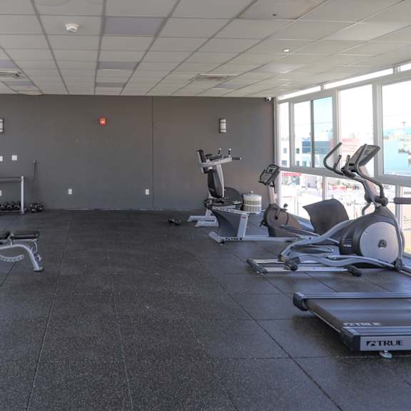 resident fitness center with treadmills, ellipticals, bikes, and other exercise equipment