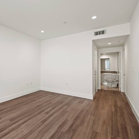 bedroom with closet and bathroom