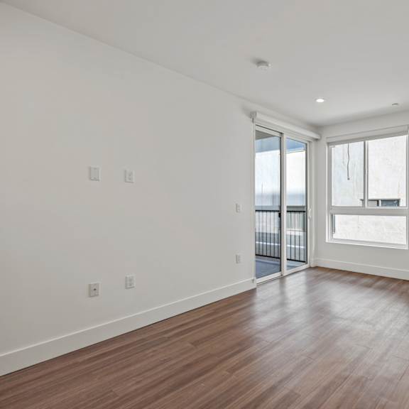 bedroom with recessed lighting, vinyl floors, windows, and patio