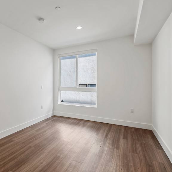 bedroom with vinyl flooring and windows