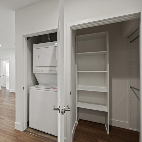 in-suite washer & dryer and hall closet with shelving