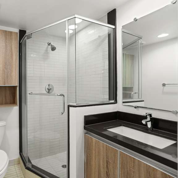 bathroom with stand-up shower and vanity cabinet storage