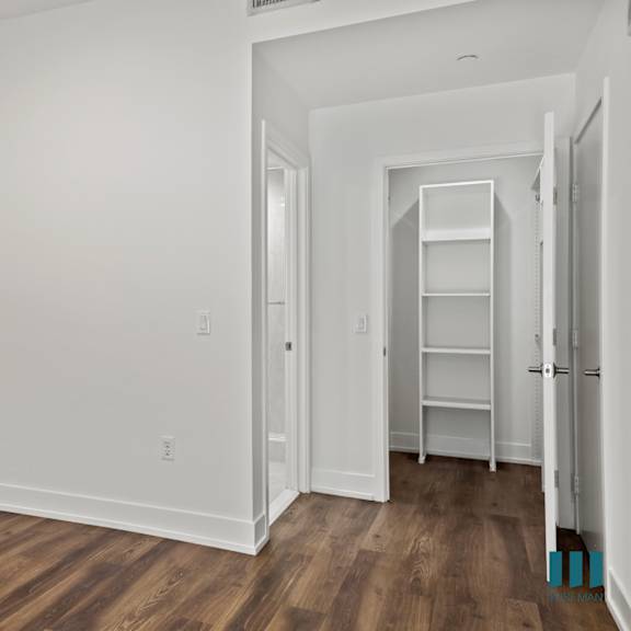 bedroom with closet with built-in shelving