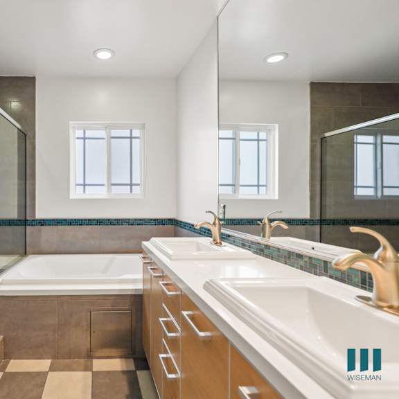 bathroom with full-size bathtub, walk-in shower, and vanity cabinet storage